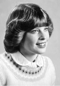 A grayscale portrait of a young woman.