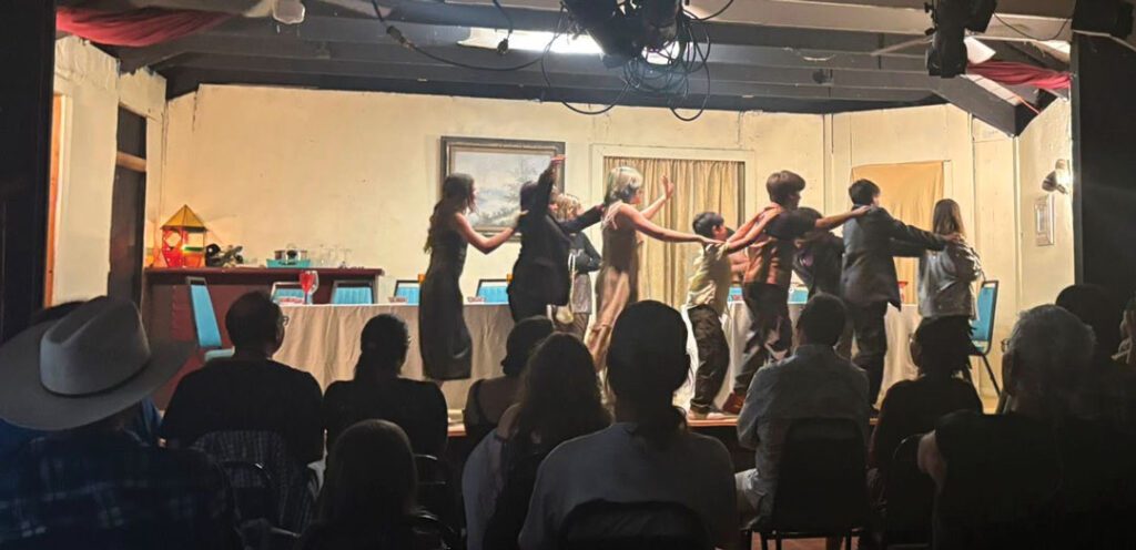 Trinity-Trust-Right-web A stage performance featuring nine children in a conga line.