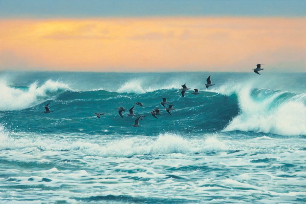 birds in front of ocean wave