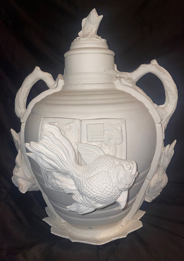 White vase with multiple koi fish swimming around the outer surface