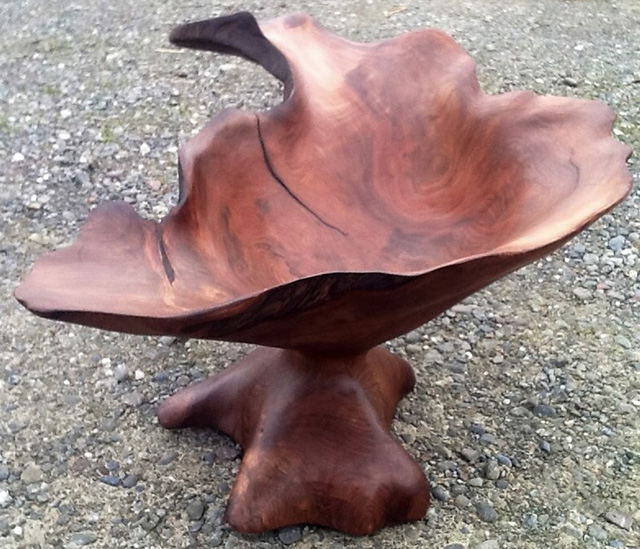 Short wooden sculpture in the shape of a stool