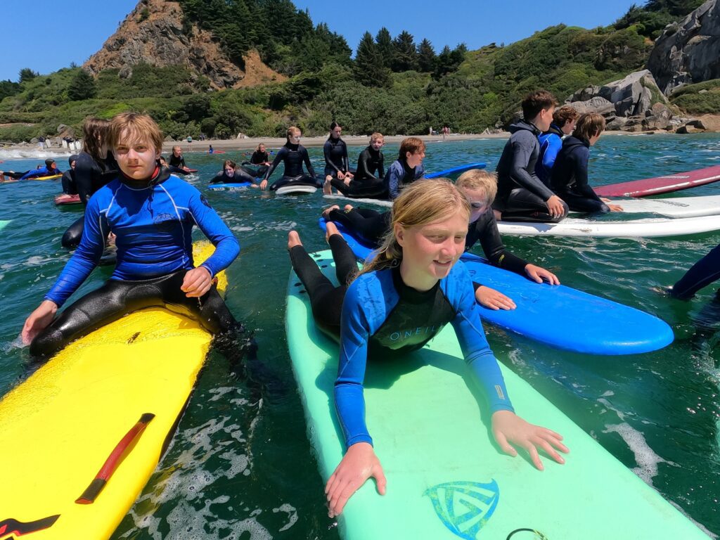 Children in water on surfboards